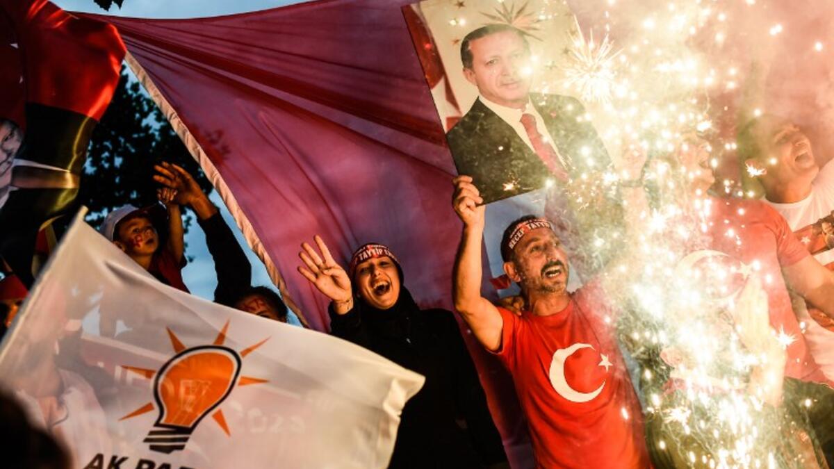 People react outside the Justice and Development Party (AKP) headquarters in Istanbul, on June 24, 2018, during the Turkish presidential and parliamentary elections, as President Erdogan won a new era. (Yasin AKGUL/AFP)