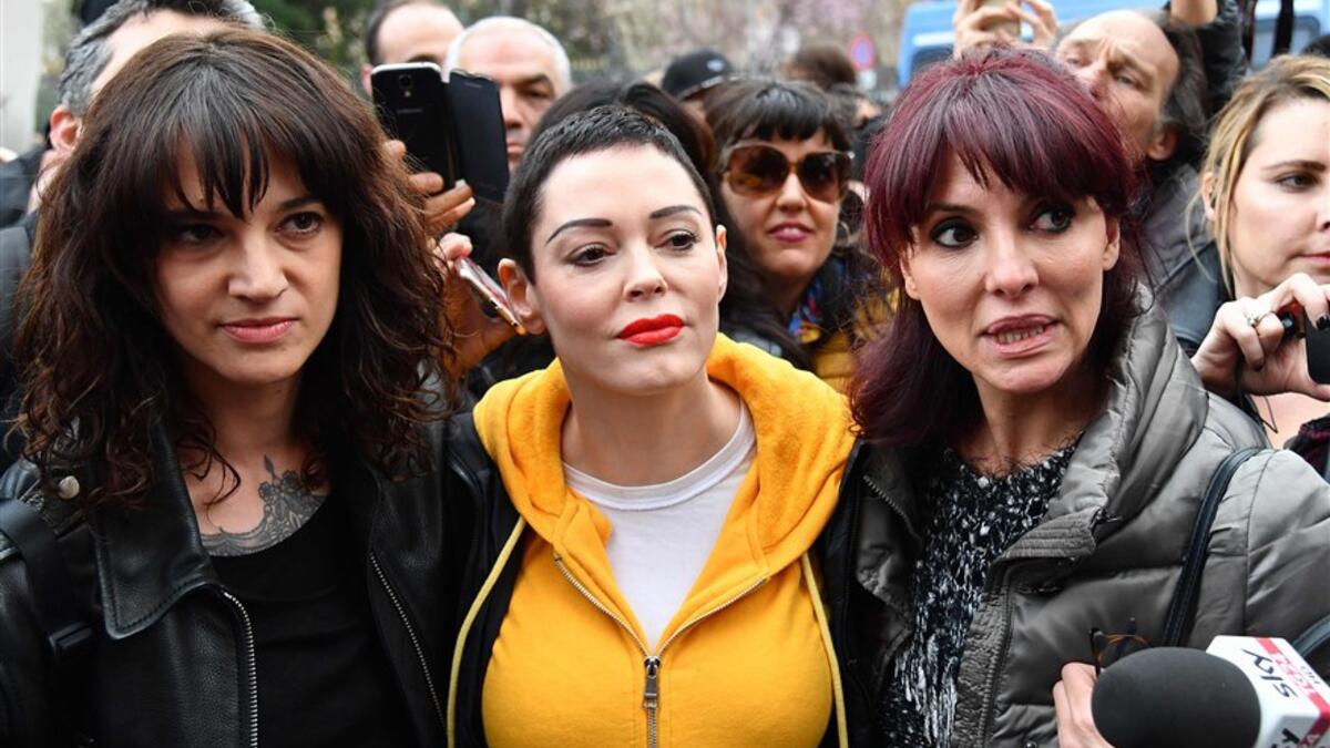 Rome -  Italian actress Asia Argento, left, along with U.S. actress Rose McGowan, center, who both accuse Harvey Weinstein of sexual assault, and Italian showgirl Miriana Trevisan, right, take part in a march organized by 'Non Una Di Meno' (Me too) movement. (AFP/Alberto Pizzoli)