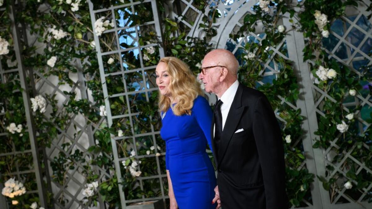 Media mogul Rupert Murdoch and wife Jerry Hall arrive in the “Booksellers Area” of the White House to attend a state dinner honoring France's President Emmanuel Macron on April 24, 2018 in Washington, DC. 
MANDEL NGAN / AFP
