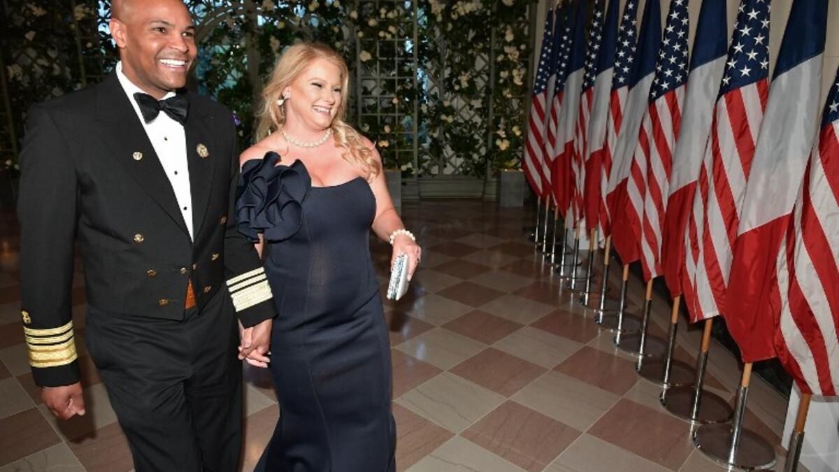 Surgeon General Jerome Adams and his wife Lacey Adams arrive in the “Booksellers Area” of the White House to attend a state dinner honoring France's President Emmanuel Macron on April 24, 2018 in Washington, DC. 
MANDEL NGAN / AFP
