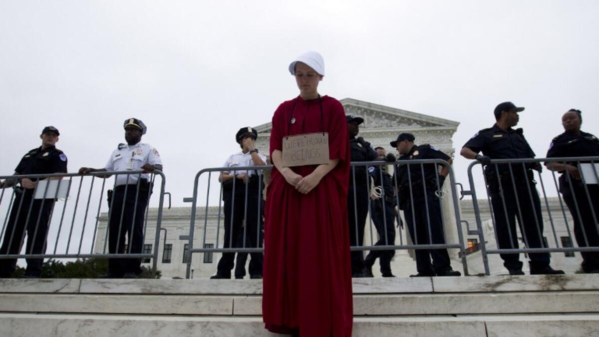 Payton Sander wearing a dress from The Handmaid's Tale protests at the steps of the US Supreme Court to protest against the appointment of Supreme Court nominee Brett Kavanaugh. (Jose Luis Magana / AFP)