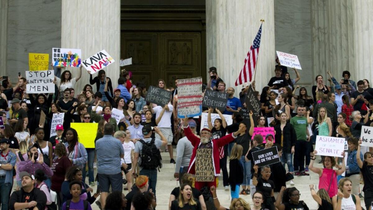 Demonstrators take the steps of the US Supreme Court to protest against the appointment of Supreme Court nominee Brett Kavanaugh in Washington DC, on October 6, 2018. (Jose Luis Magana / AFP)