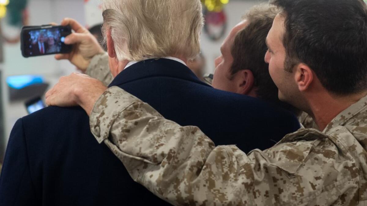 US President Donald Trump greets members of the US military during an unannounced trip to Al Asad Air Base in Iraq on December 26, 2018. SAUL LOEB / AFP