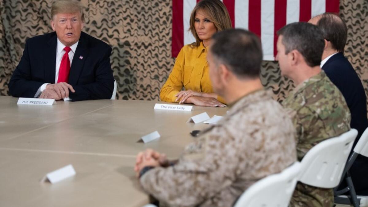 US President Donald Trump and First Lady Melania Trump attend a military briefing during an unannounced trip to Al Asad Air Base in Iraq on December 26, 2018.
SAUL LOEB / AFP