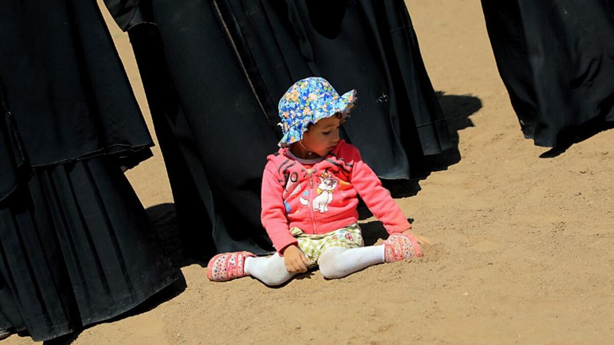 A child plays as Huthi female supporters demonstrate to support Huthi militias fighting Saudi-backed Yemeni government forces. 
Mohammed HUWAIS / AFP