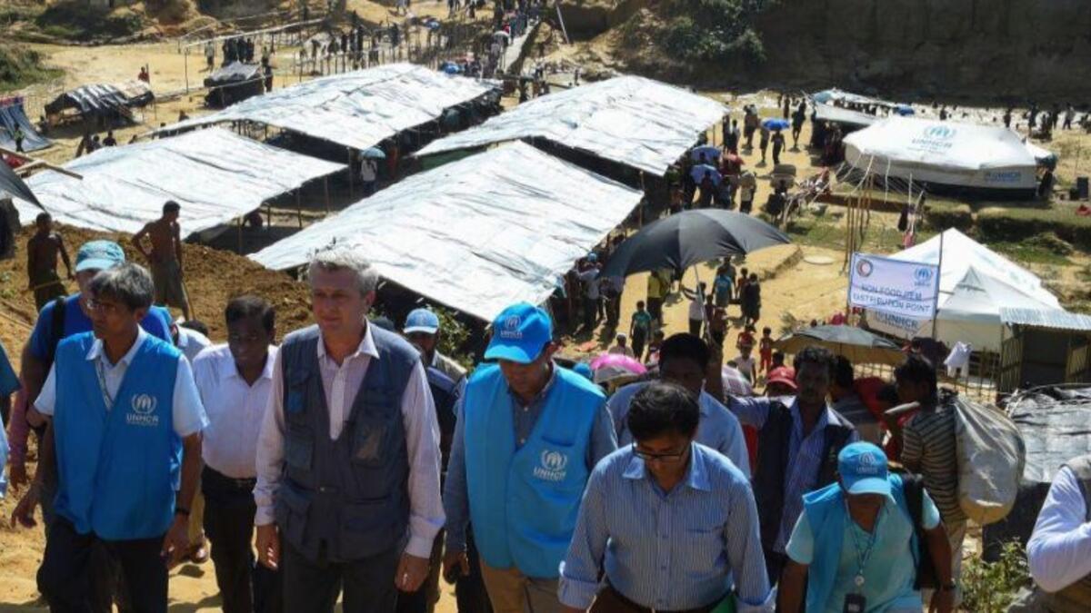 UN refugee chief Filippo Grandi talks with a refugee during a visit to Bangladesh Kutupalong refugee camp for Rohingya / AFP