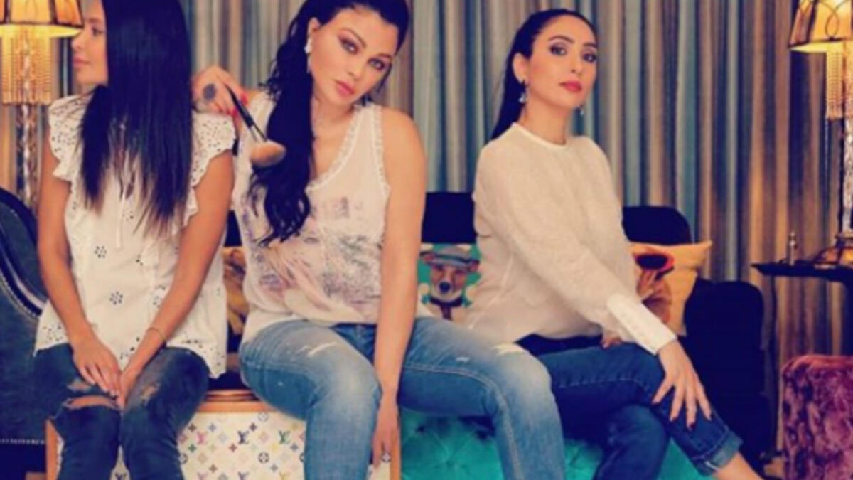 The Lebanese diva and her sisters sported casual looks with denim tight pants