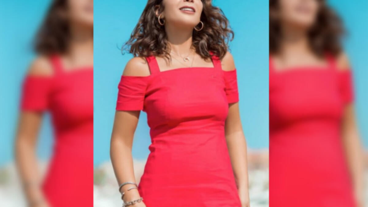 Mona sported a short red dress off shoulder dress for her latest photo shoot