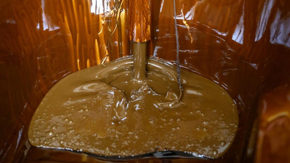 Naftalan crude oil flows from a tap to fill a bathtub during a treatment session at Sehirli Naftalan Health Center, some 300 kilometres (186 miles) from capital Baku, on March 21, 2019. Immersed up to her neck in crude oil, a Russian woman suffering from joint disease smiles in delight, confident that the treatment at a spa in northwestern Azerbaijan will cure her painful condition.  Mladen ANTONOV / AFP