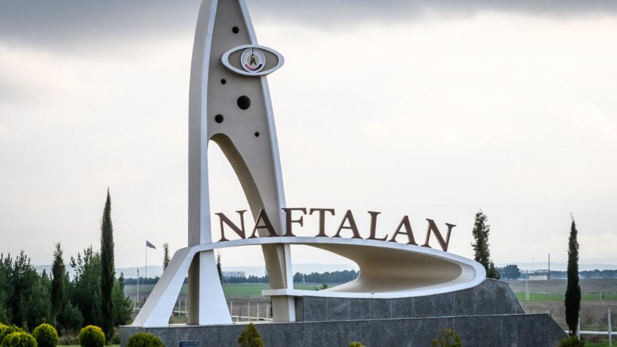 A monument at the entrance of the city of Naftalan is pictured on March 21, 2019, some 300 kilometres (186 miles) from capital Baku. Immersed up to her neck in crude oil, a Russian woman suffering from joint disease smiles in delight, confident that the treatment at a spa in northwestern Azerbaijan will cure her painful condition.  Mladen ANTONOV / AFP
