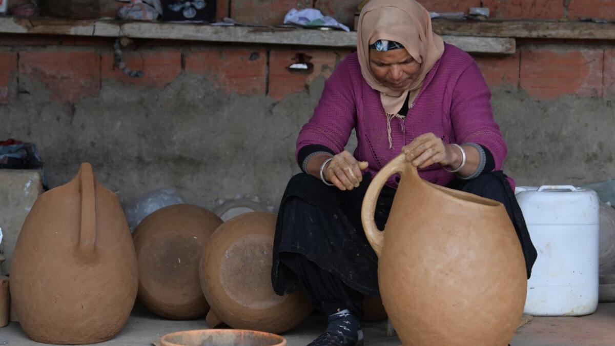 Sabiha Ayari, a Tunisian potter in her fifties, works in the village of Sejnane in the northern Tunisian province of Bizerte, about 120 kilometres (75 miles) west of the capital Tunis.  FETHI BELAID / AFP