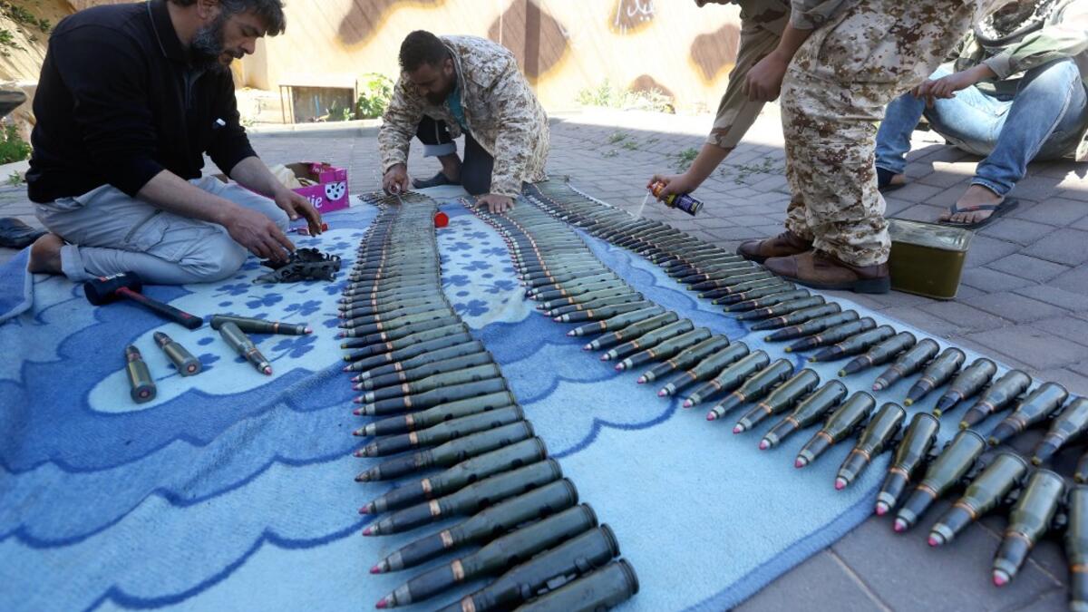 Fighters from a Misrata armed group loyal to the internationally recognised Libyan GNA prepare their ammunition before heading to the frontline as battles against Forces of Libyan strongman Khalifa Haftar continue on the outskirts of the capital Tripoli on April 9, 2019. Mahmud TURKIA / AFP