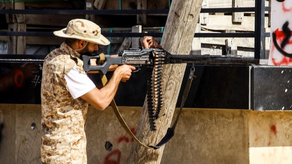 A Libyan fighter loyal to the Government of National Accord (GNA) aims a machine gun while taking during clashes with forces loyal to strongman Khalifa Haftar south of the capital Tripoli's suburb of Ain Zara, on April 10, 2019. Mahmud TURKIA / AFP