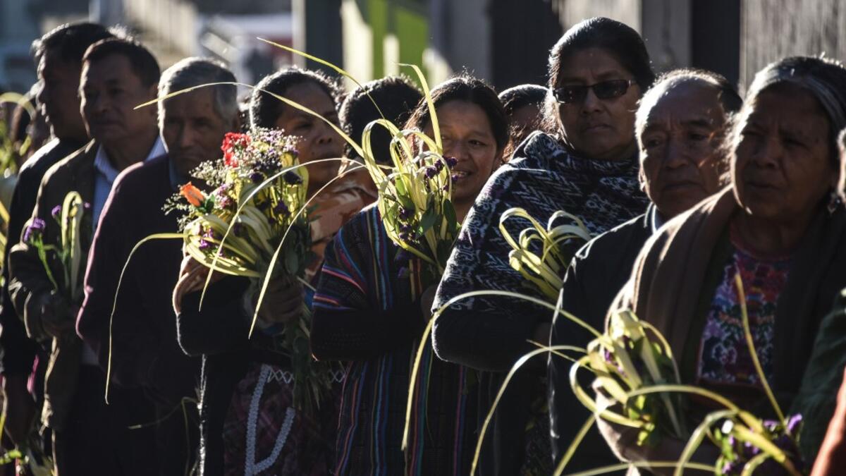 Catholic faithful take part the Palm Sunday procession on April 14, 2019 in San Pedro Sacatepequez, 30 km west of Guatemala City.  Johan ORDONEZ / AFP