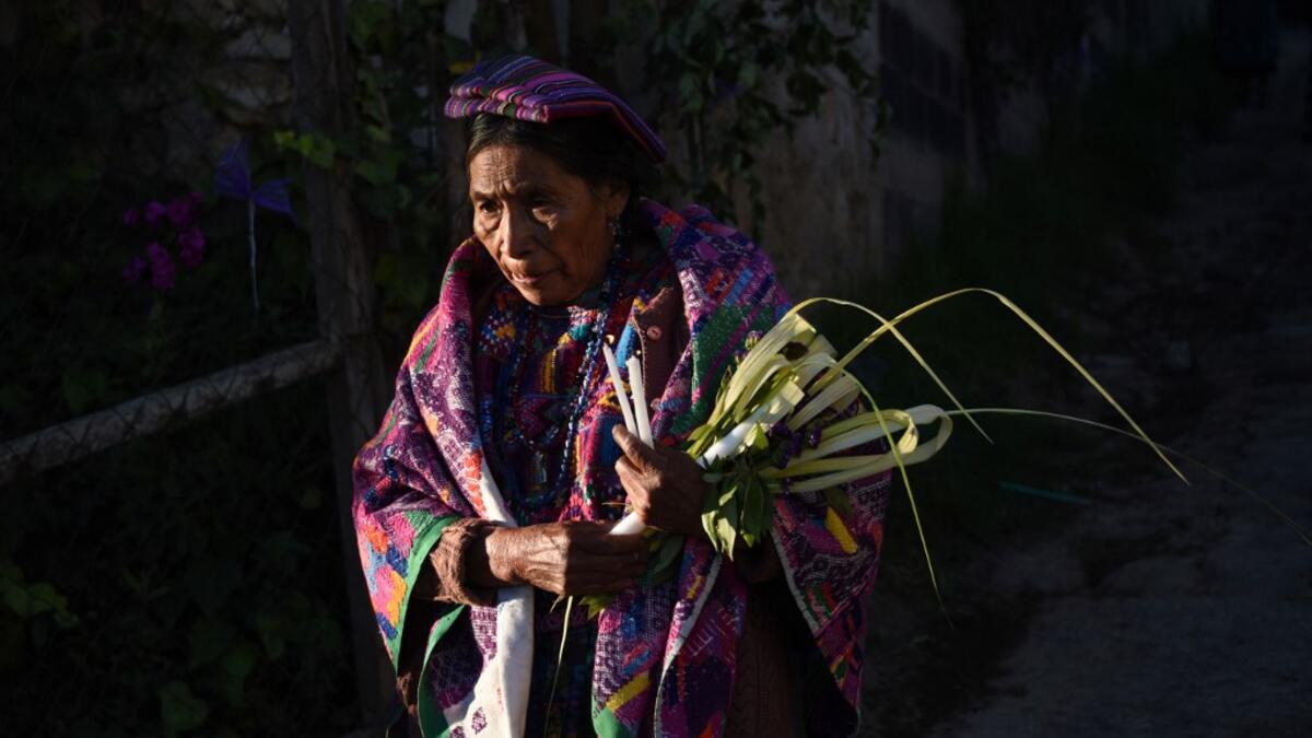 A Catholic faithful takes part the Palm Sunday procession on April 14, 2019 in San Pedro Sacatepequez, 30 km west of Guatemala City.  Johan ORDONEZ / AFP