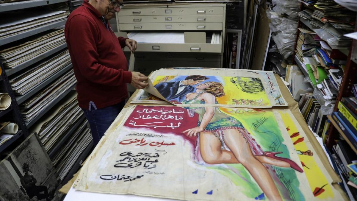 Abboudi Abu Jawdeh shows part of his vintage cinema poster collection at his office in the Lebanese capital Beirut  JOSEPH EID / AFP