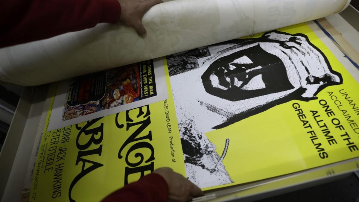 Abboudi Abu Jawdeh shows part of his vintage cinema poster collection at his office in the Lebanese capital Beirut  JOSEPH EID / AFP