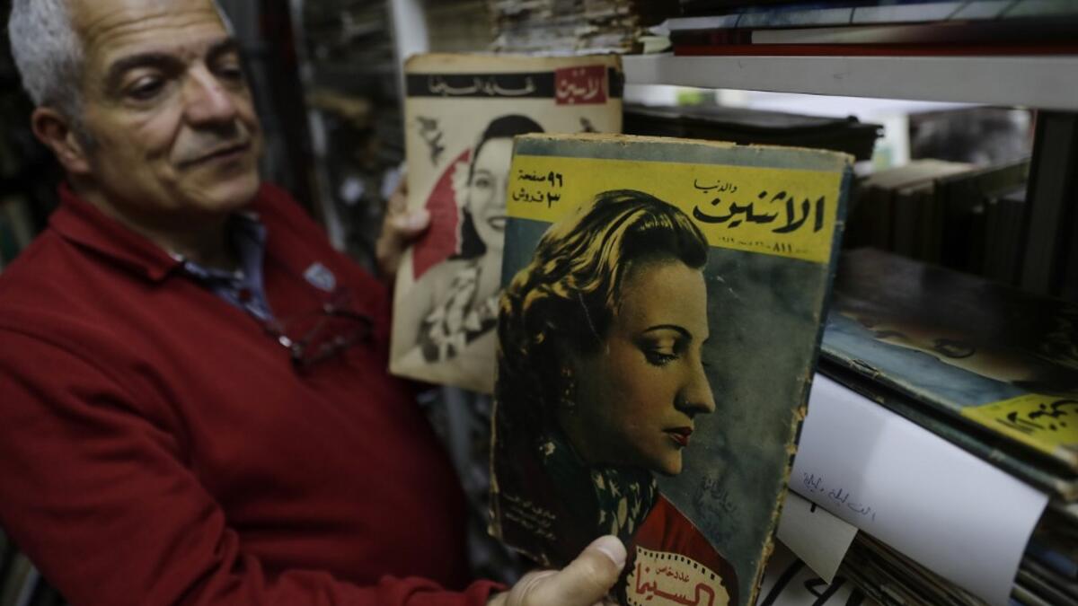 Abboudi Abu Jawdeh shows part of his vintage Lebanese cinema specialised magazines collection at his office in the Lebanese capital Beirut  JOSEPH EID / AFP