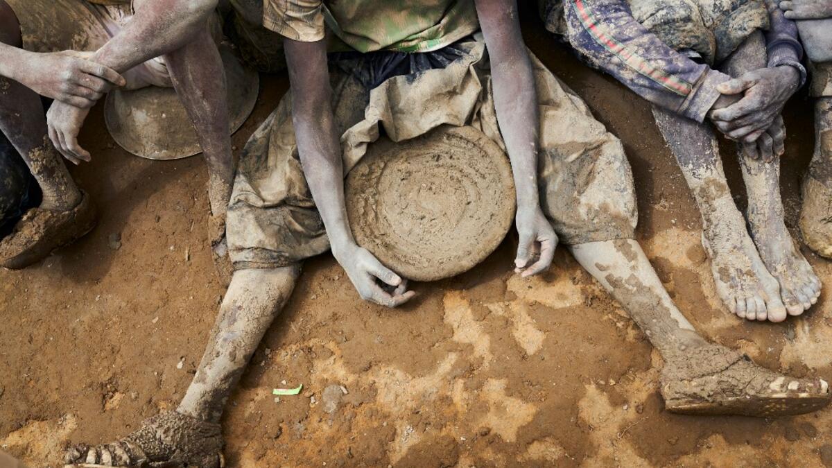 People take part in the annual rendering of the Great Mosque of Djenne in central Mali  MICHELE CATTANI / AFP