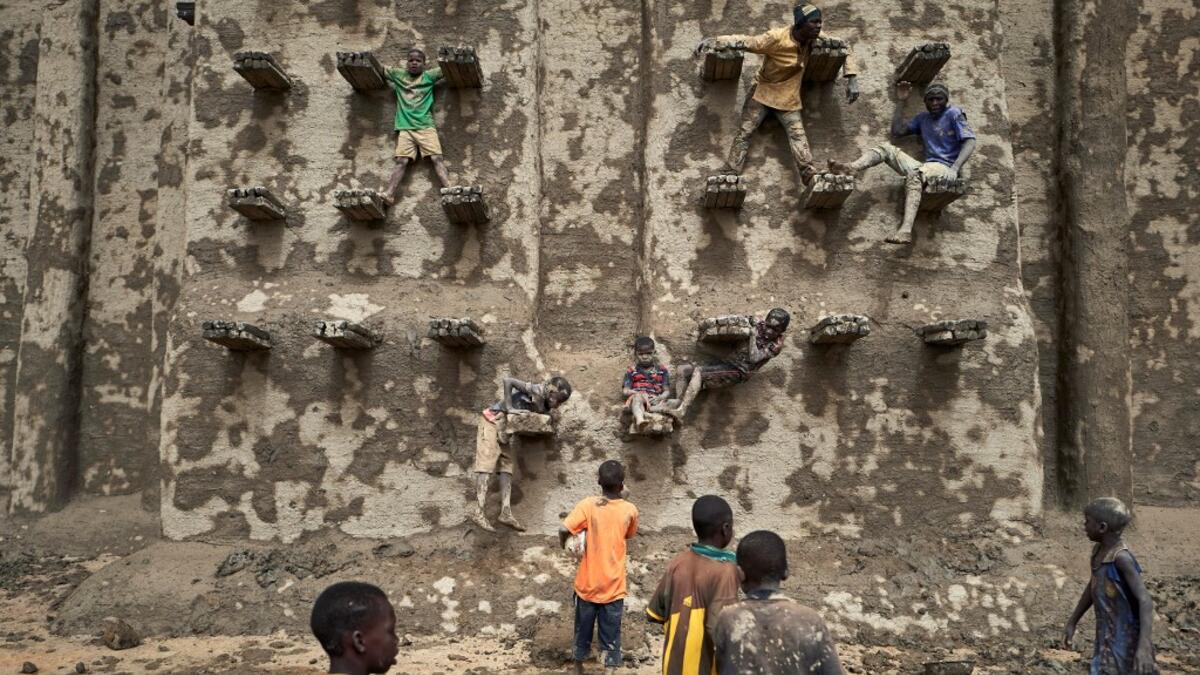People take part in the annual rendering of the Great Mosque of Djenne in central Mali  MICHELE CATTANI / AFP