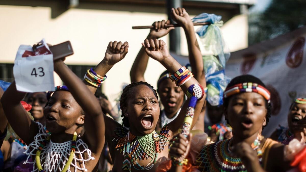 Young women dressed up in traditional attire sing and chant during an audition organised by the Indoni Culture School in the South African city of Durban. Rajesh JANTILAL / AFP
