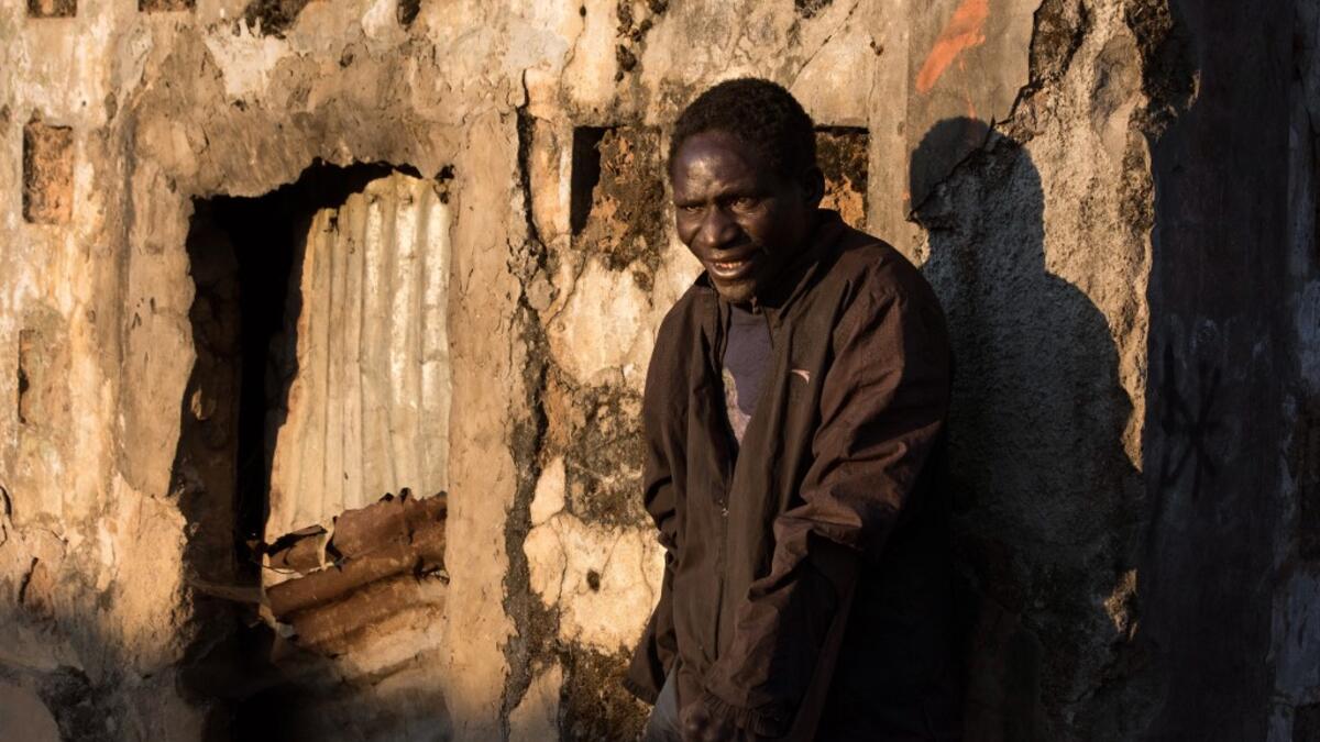 Domingo Tomas, a former soldier with the Angolan Army and now part of a group of homeless people living in a building damaged during the Angolan civil war.  RODGER BOSCH / AFP