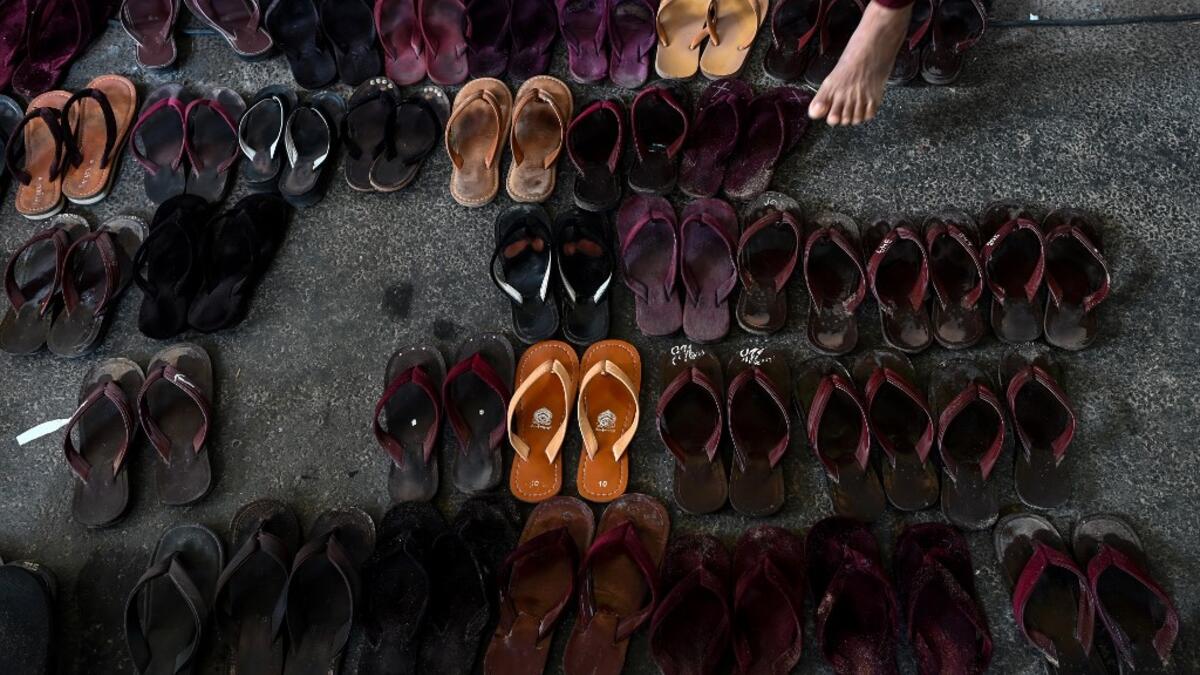 Footwear is seen as Buddhist monks, nuns, and members from the ultra-nationalist group Buddha Dhamma Parahita Foundation, previously known as Ma Ba Tha, attend the group's annual meeting in Yangon on June 17, 2019.  Ye Aung THU / AFP