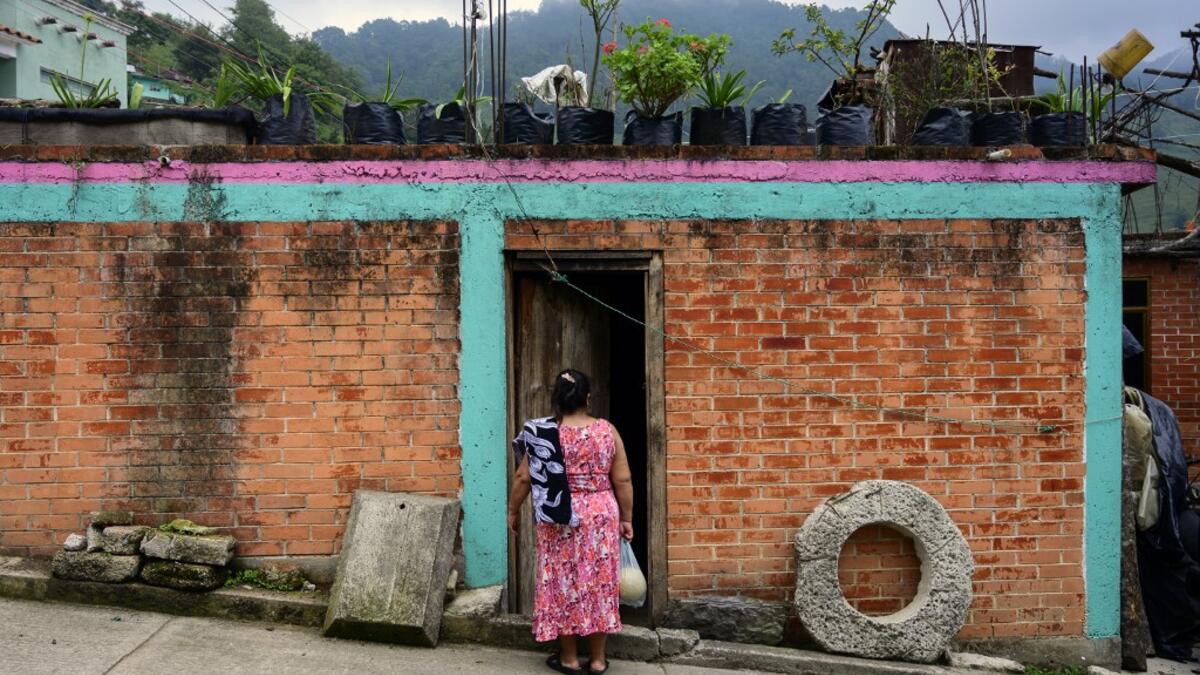 Mexican artisan Glafira Candelaria Jose, 59, of the Otomi ethnic group, stands outside her house in San Nicolas Village, in Tenango de Doria, Hidalgo state, Mexico.  Pedro PARDO / AFP