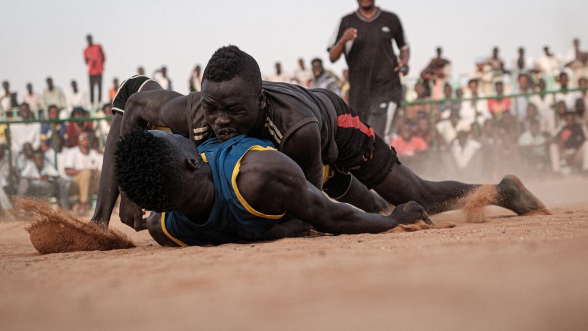 Sudanese wrestlers fight during a traditional Nuba wrestling match at the Haj Youssef stadium in the district of Khartoum.  Yasuyoshi CHIBA / AFP
