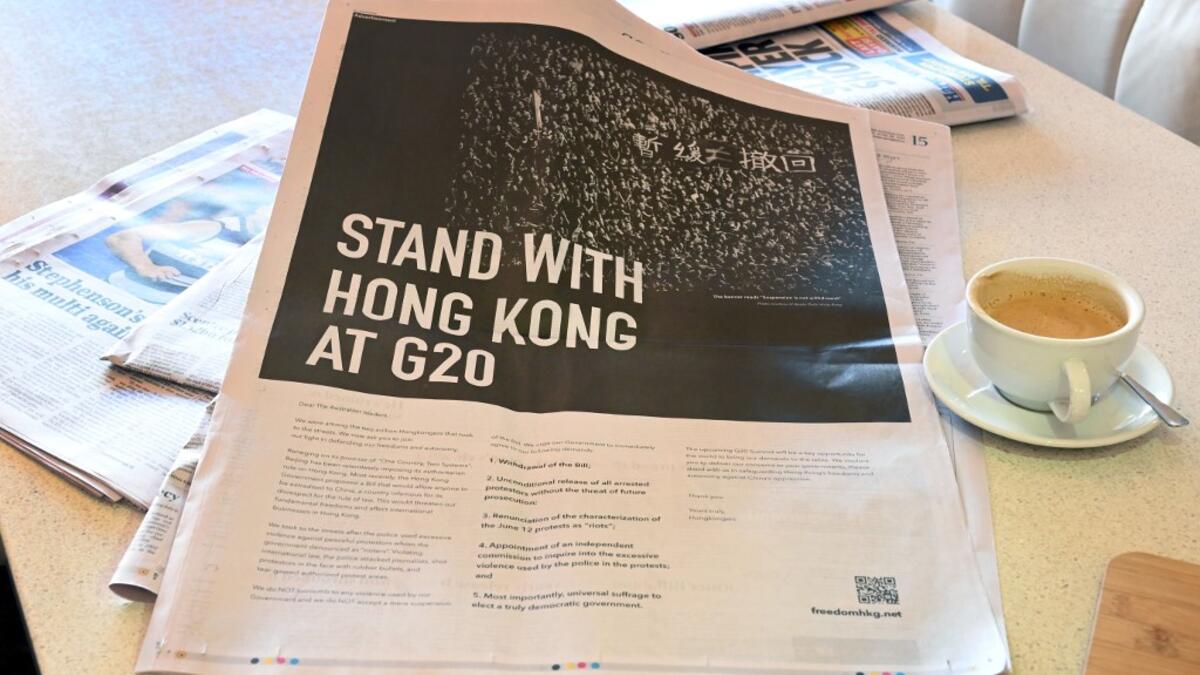 This photo illustration shows an advert placed in the national daily newspaper The Australian in Melbourne on June 28, 2019 by a Hong Kong campaign group calling for solidarity with Hong Kong protesters demanding the withdrawal of a bill that would allow extraditions to the Chinese mainland, ahead of the G20 summit in Japan.  William WEST / AFP