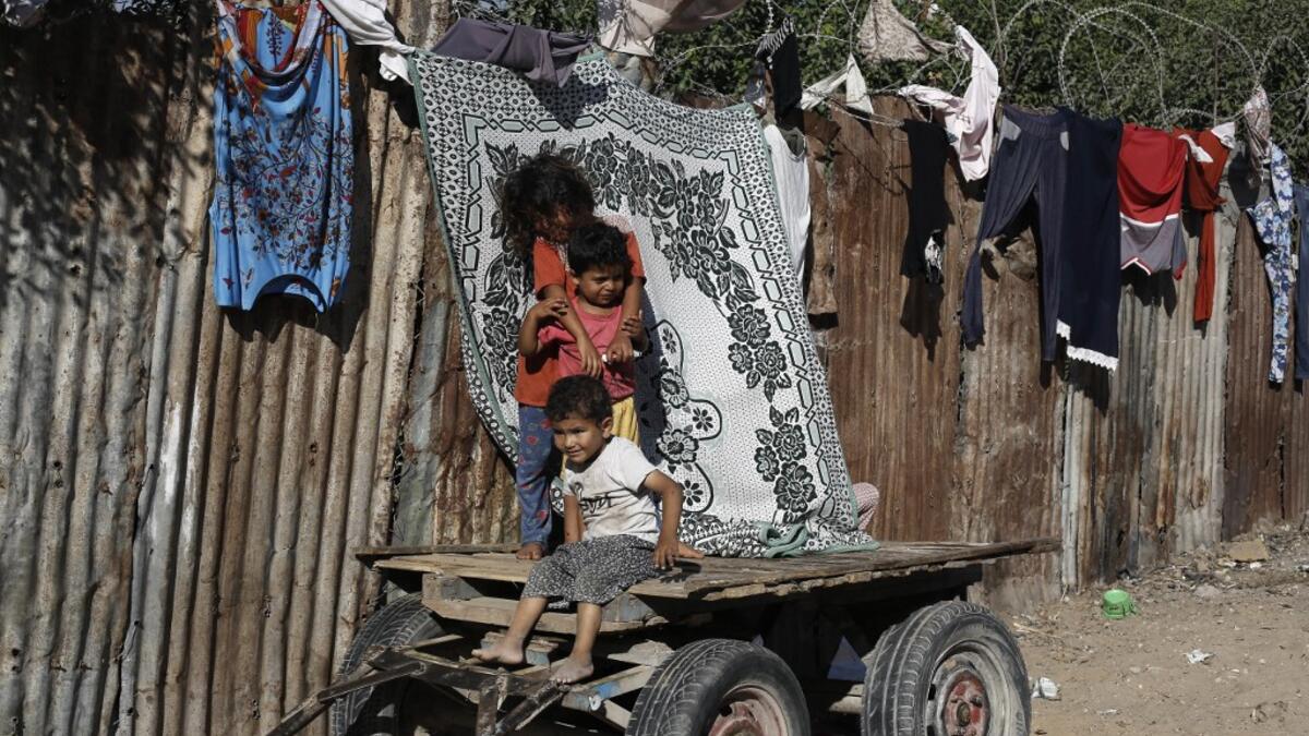 Palestinian children play at an impoverished neighbourhood in Gaza City on July 4, 2019.  MOHAMMED ABED / AFP
