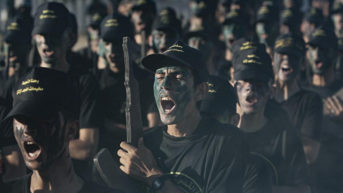 A Palestinian youth, carrying a wooden rifle, chants slogans during a military-style graduation ceremony organised by the Islamic Jihad movement in Gaza City on July 4, 2019.  MOHAMMED ABED / AFP