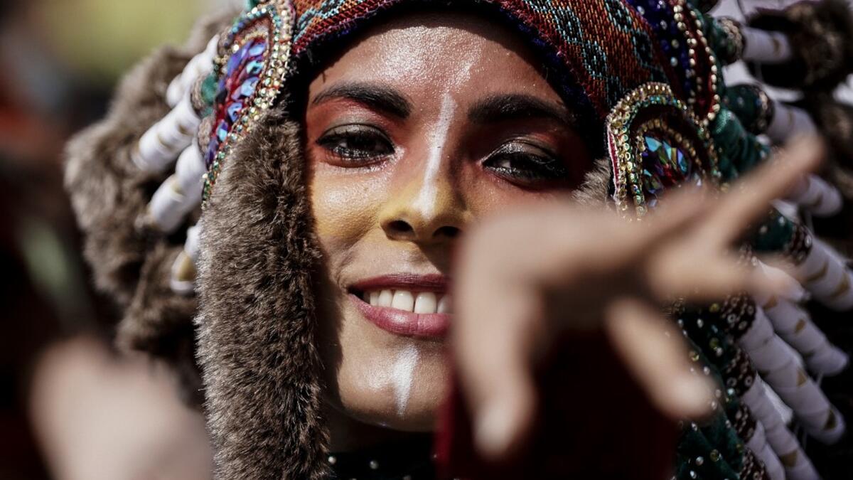 People parade during the Tropical Carnival on July, 7 2019 in Paris.  Kenzo TRIBOUILLARD / AFP