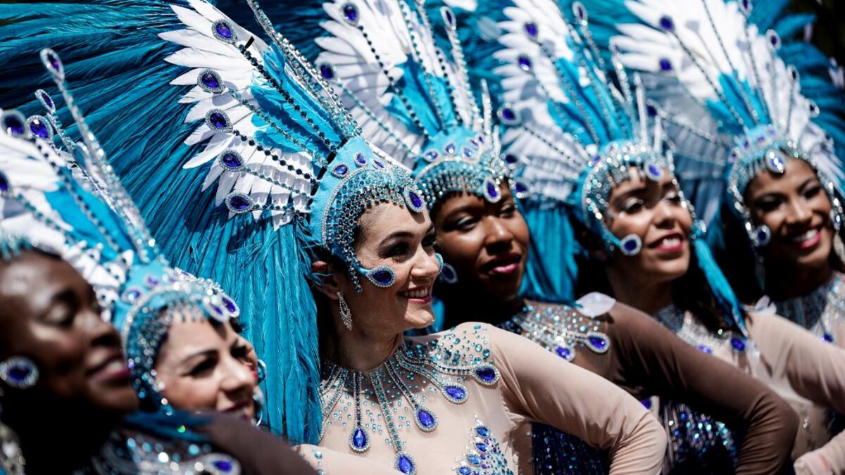 People parade during the Tropical Carnival on July, 7 2019 in Paris.  Kenzo TRIBOUILLARD / AFP