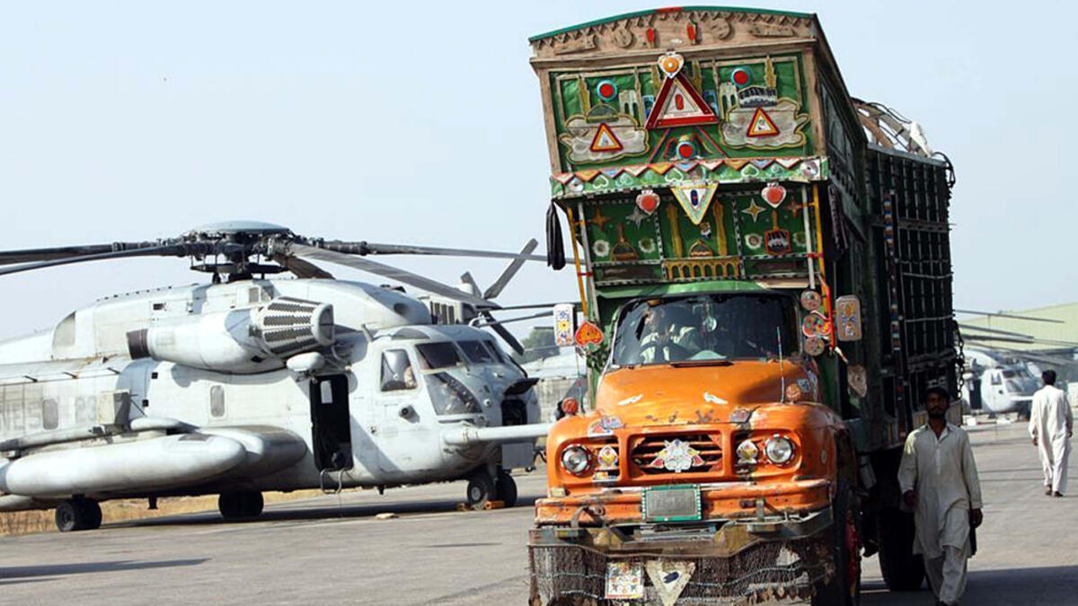 Truck departs Cantt after transferring humanitarian supplies to US military helicopter on a recent mission in Pakistan's flood  (Shutterstock)