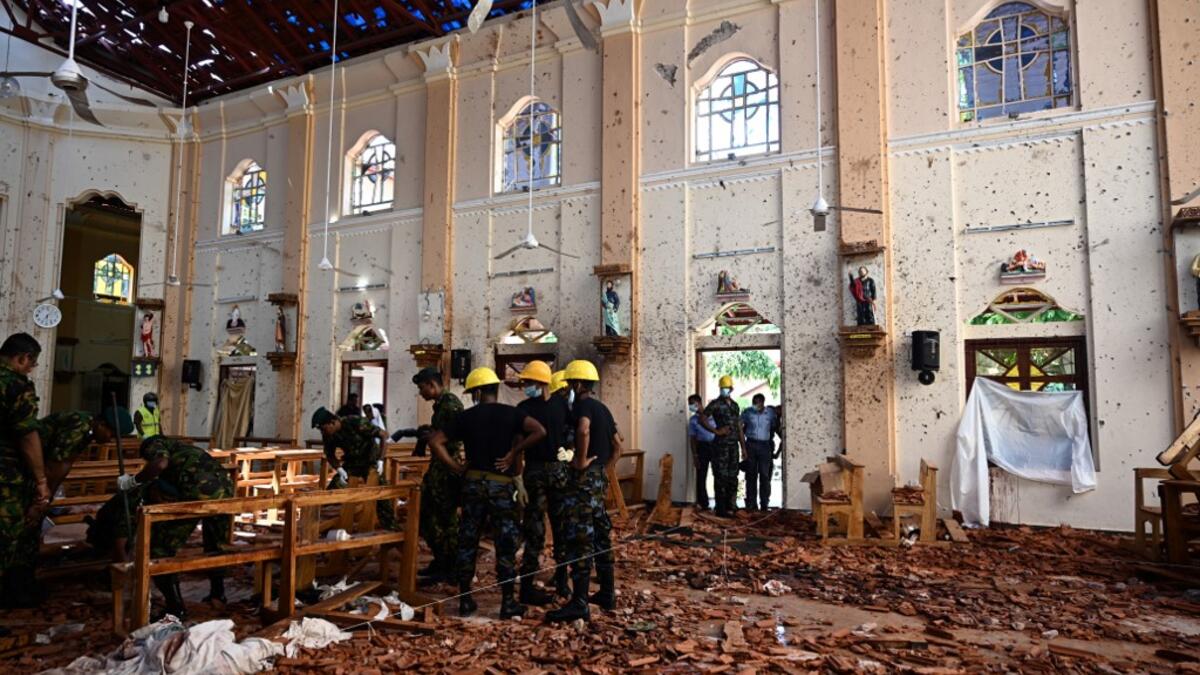 Security personnel inspect the interior of St Sebastian's Church in Negombo on April 22, 2019, a day after the church was hit in series of bomb blasts targeting churches and luxury hotels in Sri Lanka. Jewel SAMAD / AFP