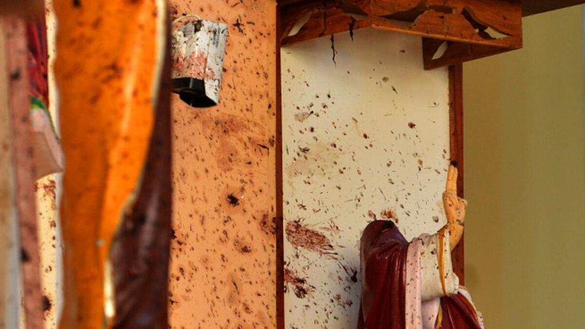 Broken statues are pictured next to shrapnel marks at St. Sebastian's Church in Negombo on April 22, 2019. ISHARA S. KODIKARA / AFP