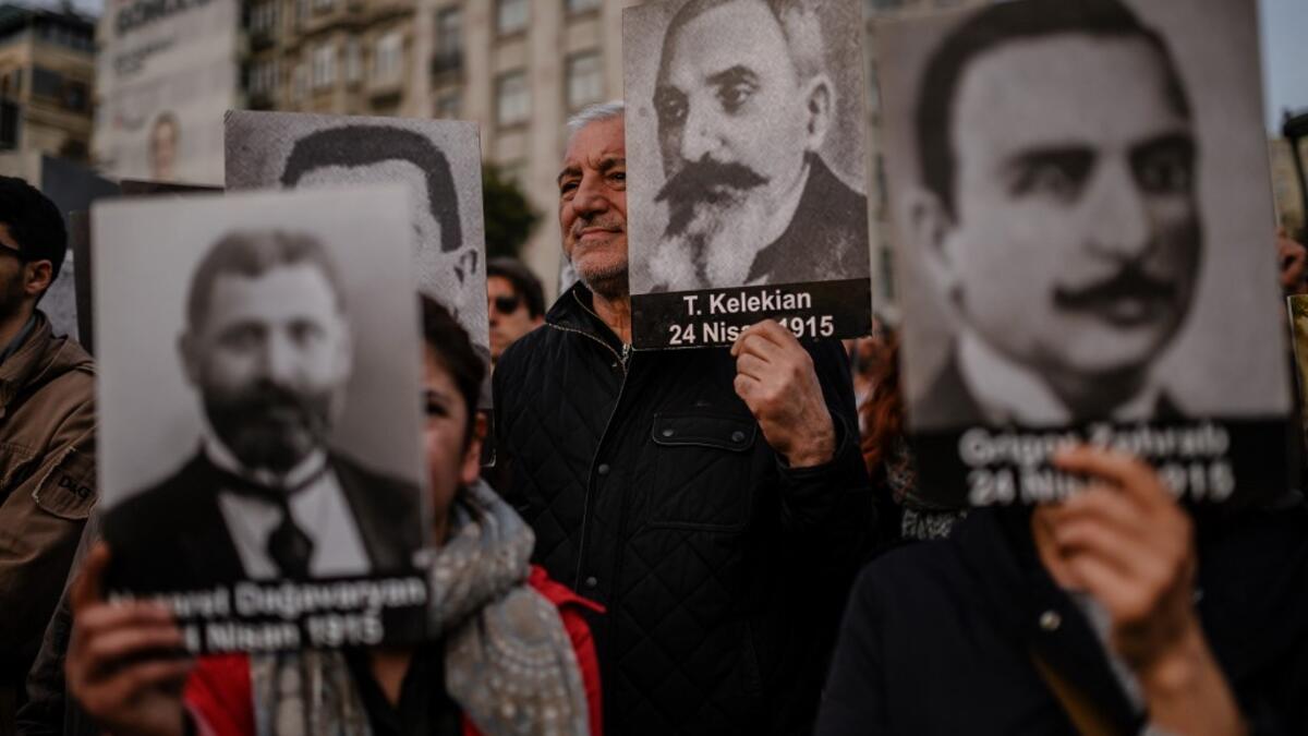 People hold portraits of Armenian intellectuals - who were detained and deported in 1915 - during a rally held to commemorate the 104th anniversary of the 1915 mass killings of Armenians in the Ottoman Empire near Istiklal avenue at Sishane square in Istanbul on April 24, 2019. BULENT KILIC / AFP