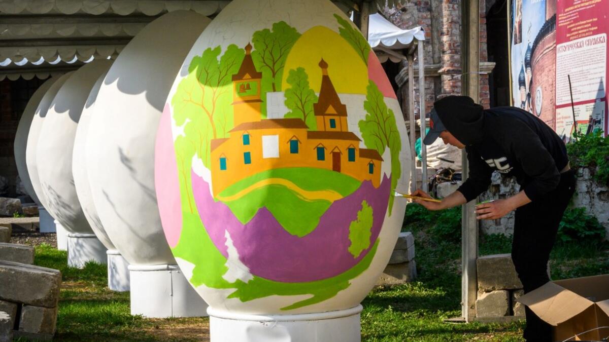 An artist paints a giant Easter egg in the yard of an Orthodox monastery in central Moscow on April 26, 2019, ahead of the Orthodox Easter on April 28, 2019. Russia celebrates the Orthodox Easter on Sunday April 28, 2019. Mladen ANTONOV / AFP