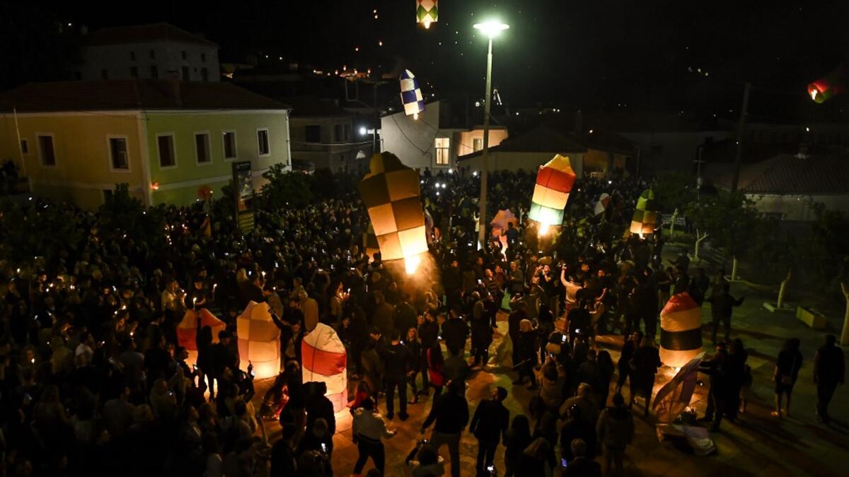 Colorful lanterns lift into in the night sky of Leonidio, a seaside town in the Peloponnese, to mark the Ressurection of Christ celebrated by the Greek Orthodox Church on April 28, 2019.  ARIS MESSINIS / AFP