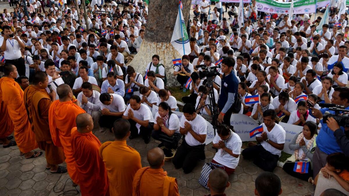 Buddhists monks bless workers during a gathering to mark International Labour Day in Phnom Penh on May 1, 2019.  TANG CHHIN Sothy / AFP