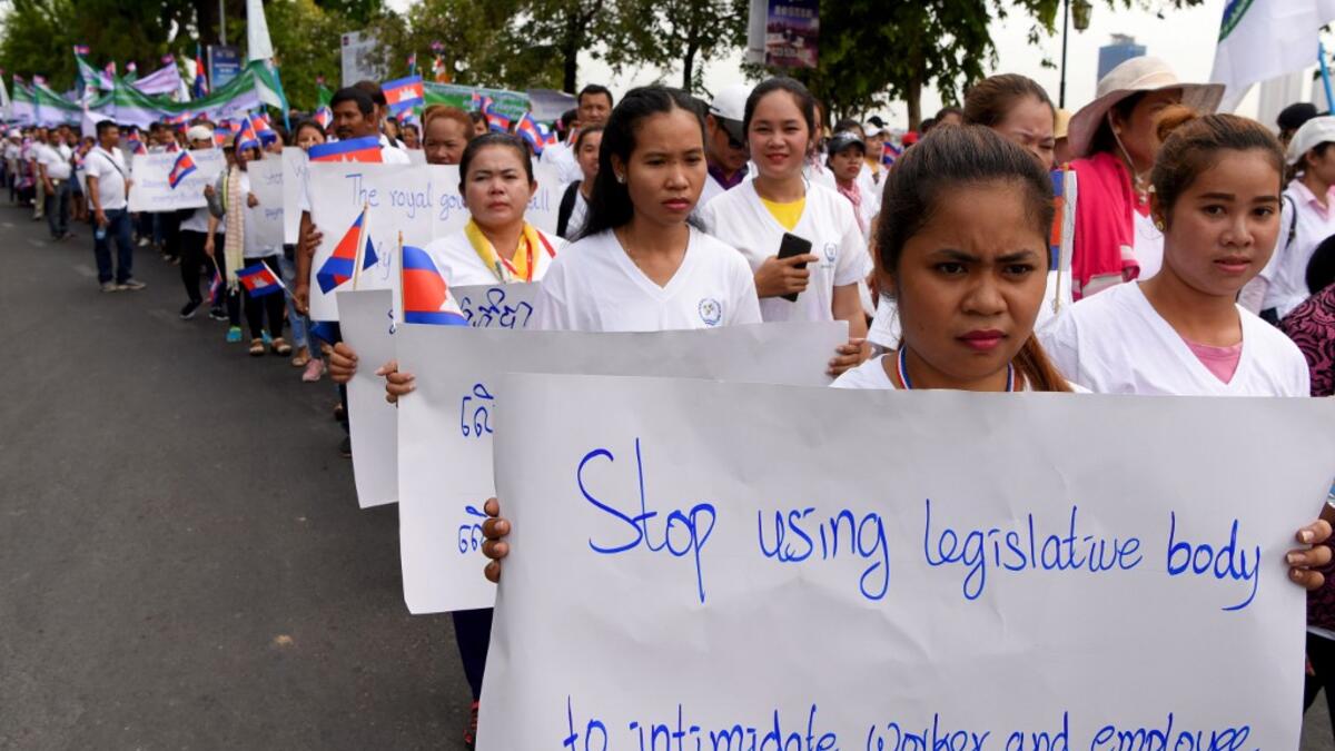 Workers march along a street to mark International Labour Day in Phnom Penh on May 1, 2019.  TANG CHHIN Sothy / AFP