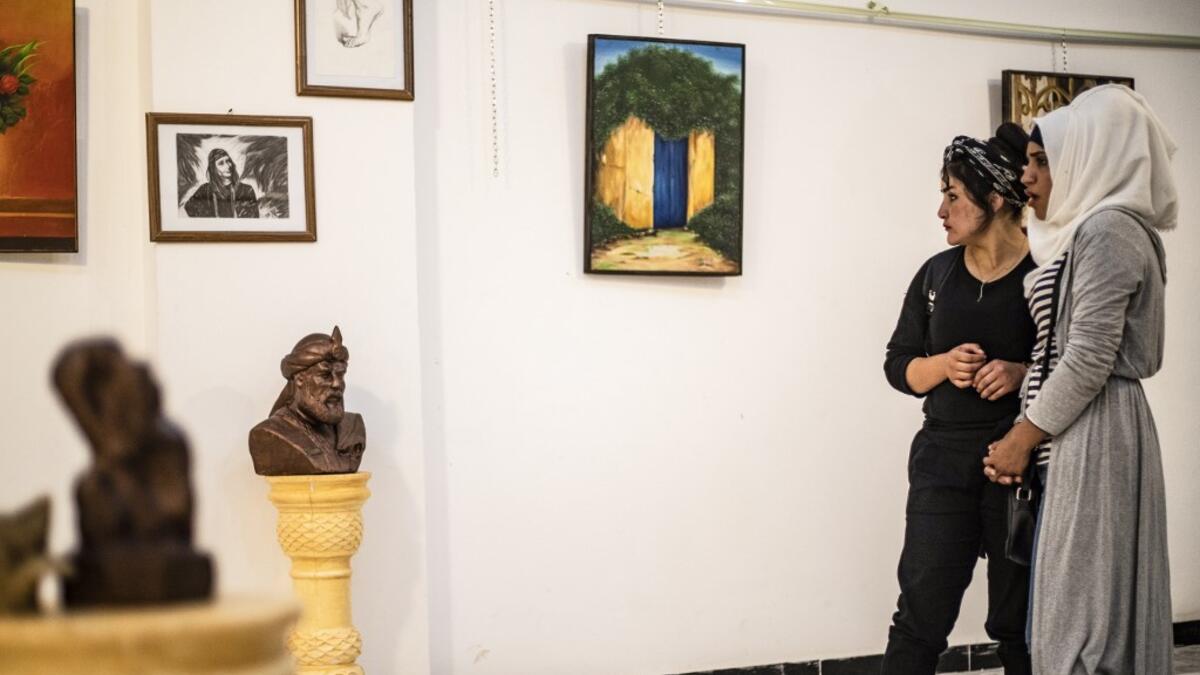 Residents of the eastern Syrian city of Raqa view artworks during an exhibition at the first cultural centre to open since ISIS rule ended there, on May 1, 2019. DELIL SOULEIMAN / AFP